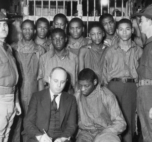 This is an image of the Scottsboro Boys in jail, awaiting trial, with their attorney.