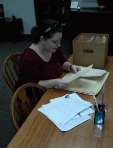 This image shows Ashley Tickle reviewing archival materials.