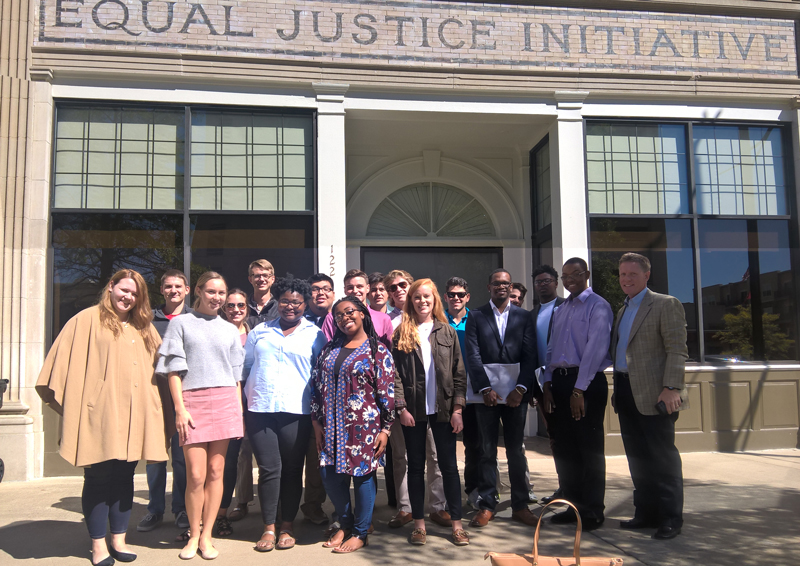 This image shows students, along with Dr. Giggie, standing outside the EJI office in Montgomery, AL.