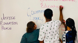 Image of Central High Students writing on a white board.