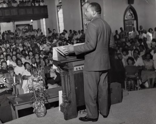 Martin Luther King from behind while addressing the crowd at First African Baptist Church